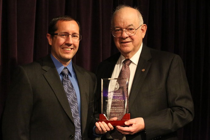 Image of 2 men holding award